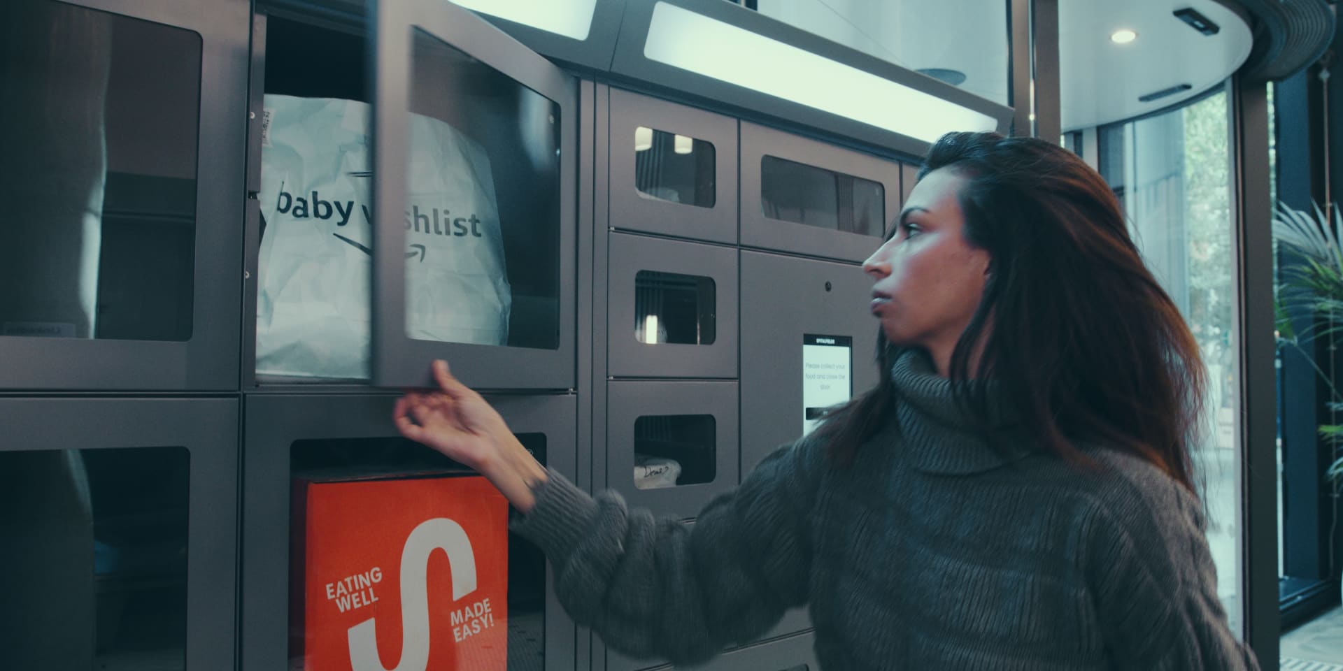 Resident collecting a food delivery from a Foodie Locker